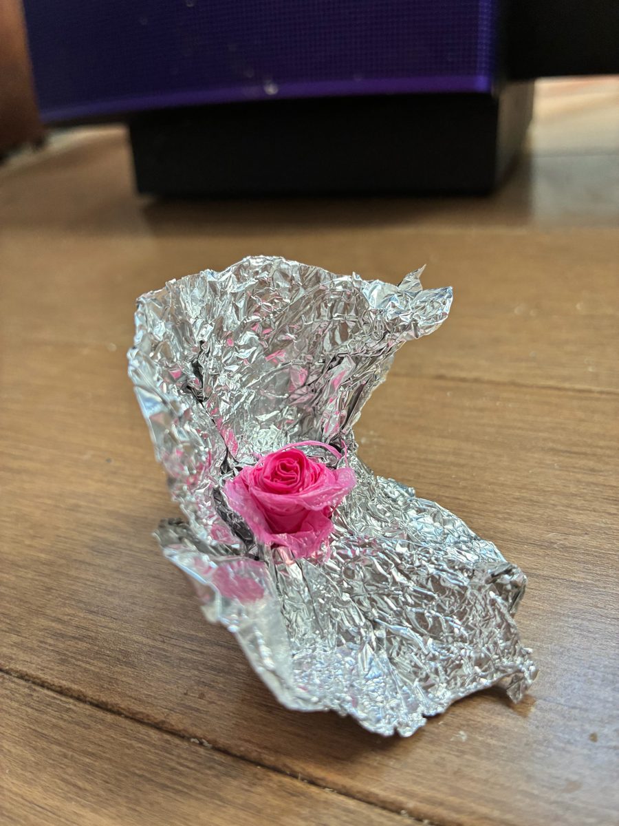 Handmade rose from plastic bag in foil cliff